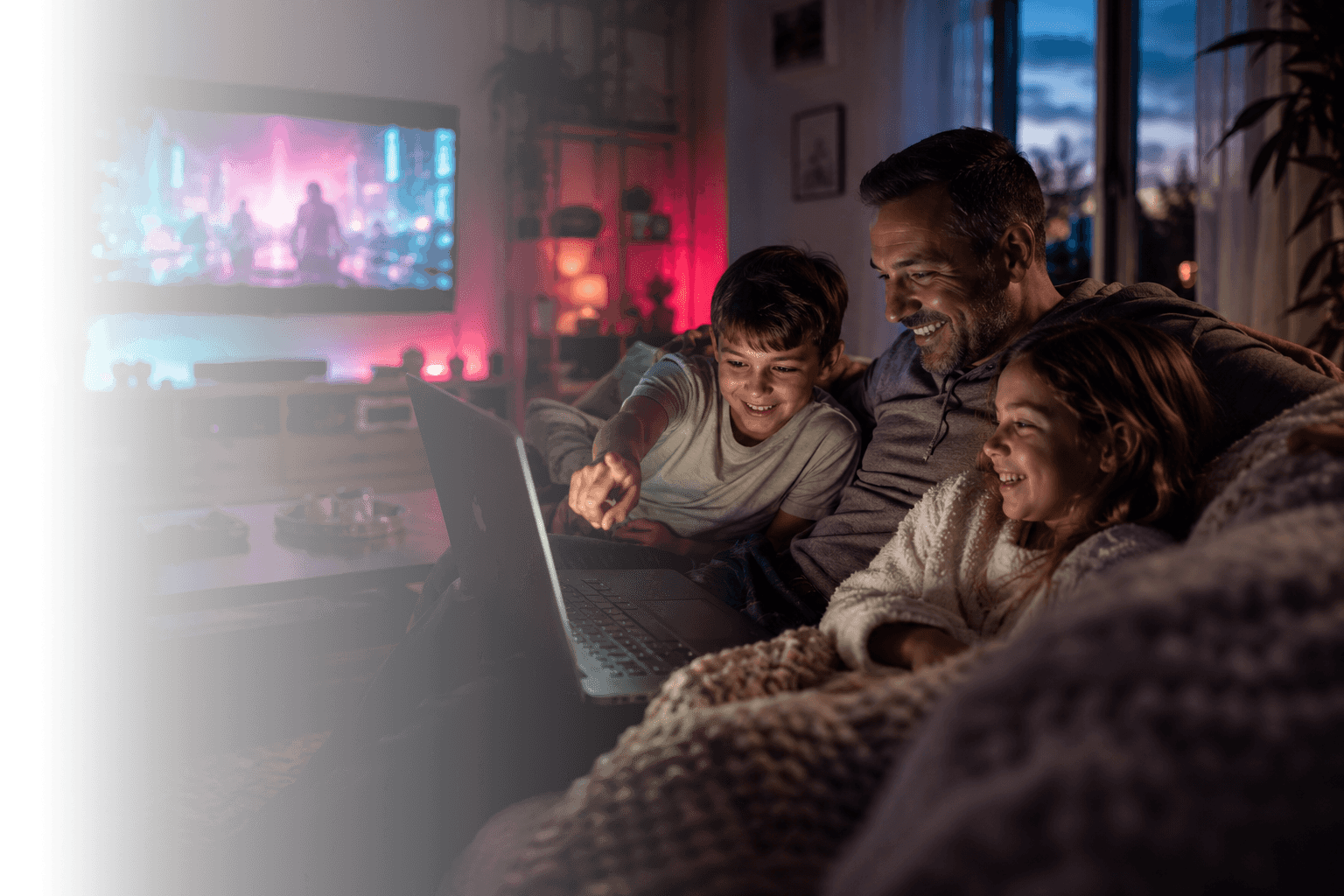 A family relaxing at home, streaming a movie and browsing on a laptop